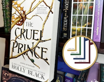 May include: A paperback book titled The Cruel Prince by Holly Black with a white cover featuring gold branches and a crown. A circular graphic displays four colored lines with labels: Small 31mm, Medium 36mm, Large 42mm, and Chunky 58mm.
