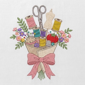 May include: An embroidery design featuring a bouquet of sewing supplies including scissors, spools of thread in pink, teal, purple, and yellow, a mannequin, a red pincushion, and buttons, all wrapped in beige paper with a large pink bow.
