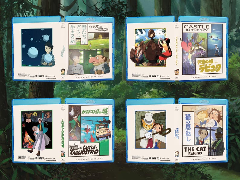 May include: A collection of Blu-ray movie cases featuring animated film artwork. The cases are in blue, with various illustrations and Japanese text. Titles include "Castle in the Sky," "The Boy and the Heron," and "The Cat Returns."