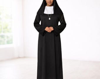 May include: A black nun costume featuring a long-sleeved dress, a white collar, and a matching black head covering. The costume includes a white wimple and a silver-colored pendant necklace. The person is wearing black shoes.