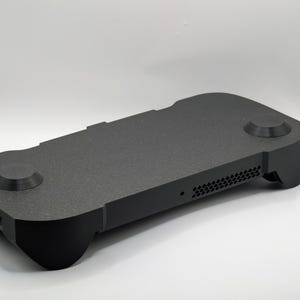 May include: A handmade wooden sign with the text "Welcome to our home" in a handwritten style. The sign is painted white with a dark stained frame. A small, decorative heart is in the bottom right corner.