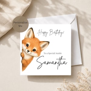 May include: A square white greeting card featuring a cartoon fox peeking from the left side. The text reads Happy Birthday! To a Special Auntie Samantha in black script and serif fonts. A matching white envelope is positioned behind the card.