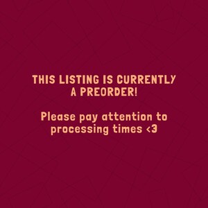 May include: Text on a burgundy background reads: "THIS LISTING IS CURRENTLY A PREORDER! Please pay attention to processing times <3". The text is in a warm orange color, with a simple sans-serif font. The background has a subtle geometric pattern.