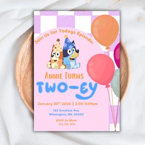 May include: A birthday invitation with a pink and purple design. The invitation features cartoon dogs, balloons, and the text "ANNIE TURNS TWO-EY". Additional text includes the date, time, and RSVP information.
