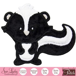 May include: Embroidered patch featuring a cartoon skunk with a black body and a white stripe down its back. The skunk has white accents on its head and tail. The patch is labeled "Handmade Patch" and includes options for customization.