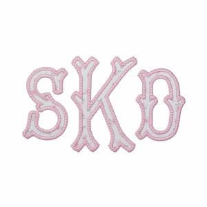 May include: The letters S, K, and O are displayed in a decorative font. Each letter features a white center with a subtle pink floral pattern, outlined by a thick, stitched pink border that creates a distinct, raised appearance for each character.