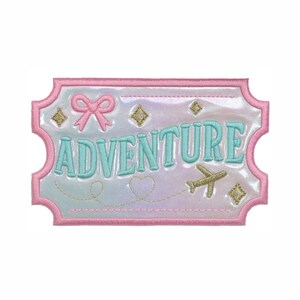 May include: A rectangular patch with a pink stitched border on an iridescent white background. It features the word ADVENTURE in light blue embroidery, a pink bow, gold embroidered stars, a gold airplane, and a gold stitched heart trail.