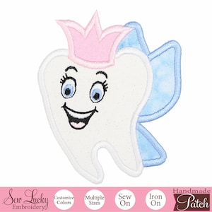 May include: A white tooth with a pink crown and blue wings, smiling with blue eyes. The tooth is a handmade iron-on patch.