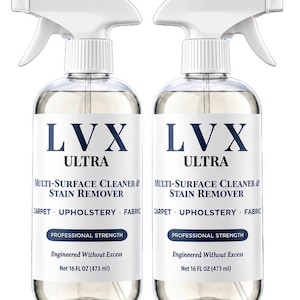 May include: Two clear plastic spray bottles of LVX Ultra Multi-Surface Cleaner & Stain Remover. Each bottle features a white trigger sprayer, a label with dark blue text, and a net volume of 16 FL OZ. The cleaner is designed for carpet, upholstery, and fabric.