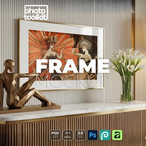 May include: A framed art print with a gold frame, featuring a vintage illustration of two women in ornate costumes. A gold geometric sculpture sits on a marble-topped cabinet. The word "FRAME MOCKUP" is displayed on the artwork.