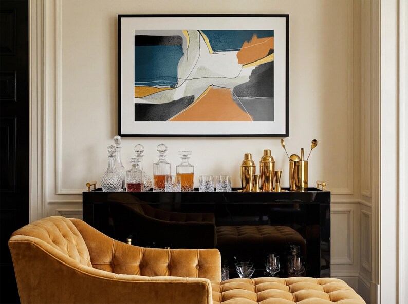 May include: A black bar cabinet with gold bar tools, cocktail shakers, and crystal decanters. An abstract painting hangs above the bar. A tufted, mustard-colored chaise lounge is in the foreground.