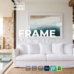 May include: A white sofa with four square pillows sits on a woven rug in front of a large framed artwork. The artwork features blue and tan abstract shapes. The words "FRAME MOCKUP" are displayed in large white letters.