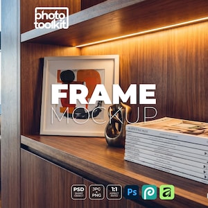 May include: A frame mockup with the word "FRAME MOCKUP" in large white letters. The frame is on a wooden shelf with a stack of magazines and a decorative sculpture. The background is a wooden wall.
