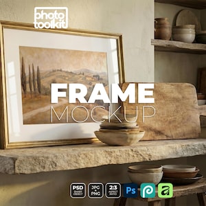 May include: A framed landscape painting with a gold frame is displayed on a stone shelf. The image is part of a mockup, with the text "FRAME MOCKUP" overlaid on the image. Other items include wooden bowls, a cutting board, and a small wooden stool.