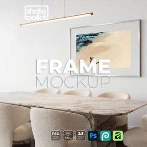 May include: A framed beach scene hangs above a marble dining table with cream-colored chairs. The image is a mockup, with the text "FRAME MOCKUP" in large white letters. A modern light fixture hangs above the table.