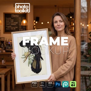 May include: A rectangular light wood picture frame containing a botanical-style illustration of a black cockatoo perched on a branch with yellow tail feathers. The frame is held upright, displaying the artwork against a light-colored background.