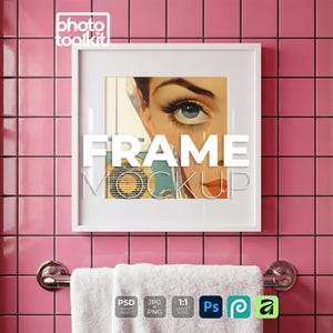 May include: A white framed art print with the text "FRAME MOCKUP" is displayed on a pink tiled wall. The artwork features a vintage illustration of a woman's face. A white towel hangs below on a chrome towel rack.