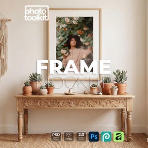 May include: A framed photo mockup with the text "FRAME MOCKUP" in large white letters. The frame is above a wooden table with carved details, holding potted succulents. A macrame wall hanging is on the left.