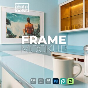 May include: A white picture frame mockup hanging on a light blue wall above a counter. The frame contains an image of a person sitting on a beach. The text "PHOTO TOOLKIT", "FRAME MOCKUP", "PSD", "JPG", "PNG", "2:3", "Ps", and "RT-004" are visible.