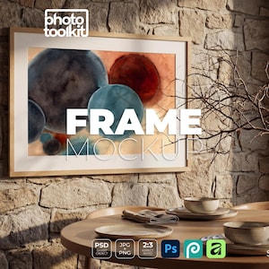 May include: A framed artwork with abstract watercolor spheres in shades of blue, red, and orange hangs on a stone wall. The frame is light wood. The text "FRAME MOCKUP" is displayed on the artwork. A table is set with plates and bowls.