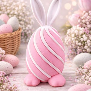May include: A pink Easter egg decoration with white stripes and bunny ears. The egg is standing on two pink feet. Other pastel-colored eggs and flowers are in the background, creating a festive spring theme.