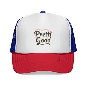 May include: A trucker hat with a red peak, white front panel, and blue mesh back. The front panel displays the text "Pretti Good" in a script font with a heart design. The hat has a blue button on top.