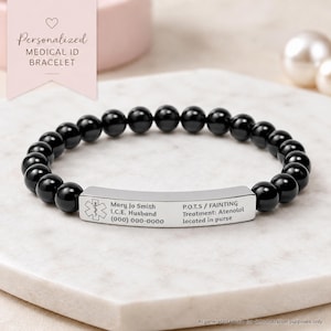 May include: A stretch bracelet featuring smooth, round black beads and a curved silver-tone metal bar. The bar is engraved with a medical caduceus symbol and text: Mary Jo Smith, I.C.E. Husband, (000) 000-0000, P.O.T.S / FAINTING, Treatment: Atenolol, located in purse.