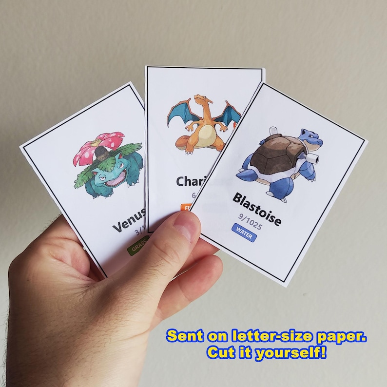 Pu&ograve; includere: Tre carte collezionabili di Pok&eacute;mon con Venusaur, Charizard e Blastoise. La carta Venusaur ha un design verde e rosa, la carta Charizard ha un design arancione e blu e la carta Blastoise ha un design blu e marrone. Il testo sulle carte include i nomi e i numeri.