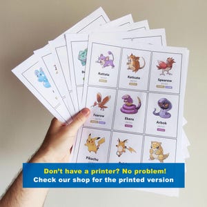 May include: A hand holding a stack of printed cards featuring cartoon characters. The cards display various characters with their names and numbers. A blue banner at the bottom reads, "Don't have a printer? No problem! Check our shop for the printed version."