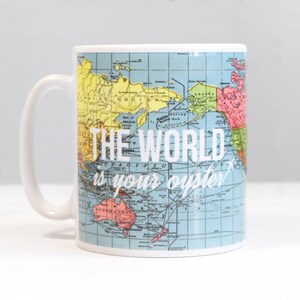 May include: White ceramic mug with a vintage world map design. The text "THE WORLD is your oyster" is printed in white on the mug.