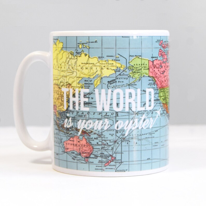 May include: White ceramic mug with a vintage world map design. The text "THE WORLD is your oyster" is printed in white on the mug.