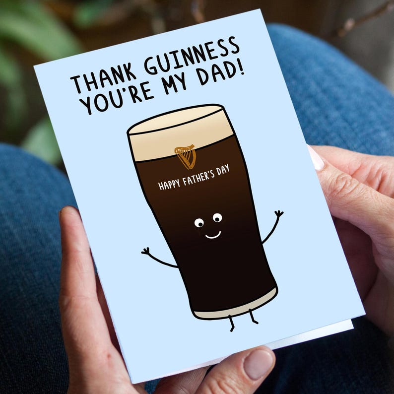 May include: A Father's Day card with a light blue background. The card features a cartoon pint of Guinness with arms and legs, and the text "THANK GUINNESS YOU'RE MY DAD!" and "HAPPY FATHER'S DAY".
