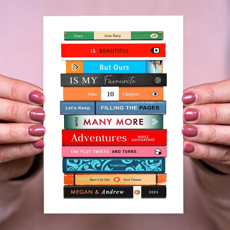 Puede incluir: Una pila vertical de lomos de libros coloridos con el texto Every Love Story IS BEAUTIFUL But Ours IS MY Favourite After 10 Chapters Let's Keep FILLING THE PAGES WITH MANY MORE Adventures WHILE NAVIGATING THE PLOT TWISTS AND TURNS Together Here's To The Next Volume MEGAN & ANDREW 2025.