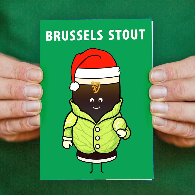 May include: A greeting card with the words "BRUSSELS STOUT" in white text. The card features a cartoon stout wearing a Santa hat and a green jacket. The stout has a smiling face and is set against a green background.