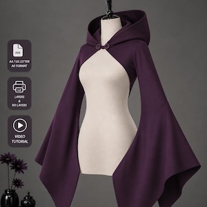 May include: A dark purple hooded cape with flared sleeves, shown on a mannequin. The cape has two buttons at the neck. Text at the top says "GET FREE PATTERN" and "SIZE 2XS-4XL".
