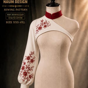 Puede incluir: Un top de un solo hombro color crema con cuello alto rojo y una manga larga. La prenda presenta bordados florales rojos en el hombro y la manga. El texto dice: NAUM DESIGN SEWING PATTERN PDF DOWNLOAD A4 & US LETTER SIZE XXS-4XL.
