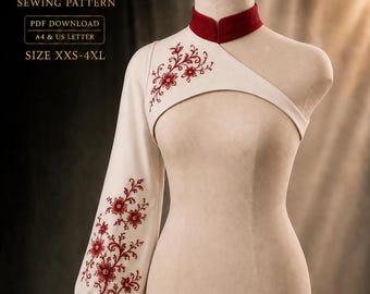 Könnte beinhalten: Ein cremefarbenes One-Shoulder-Oberteil mit hohem rotem Kragen und einem langen Ärmel. Das Kleidungsstück ist mit roter Blumenstickerei an Schulter und Ärmel verziert. Text: NAUM DESIGN SEWING PATTERN PDF DOWNLOAD A4 & US LETTER SIZE XXS-4XL.