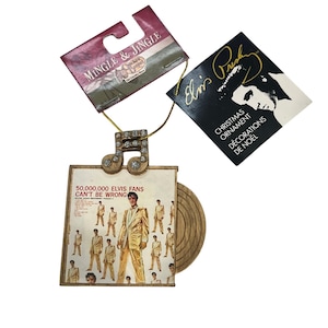 May include: A Christmas decoration featuring Elvis Presley. The ornament is shaped like a musical note with rhinestone detailing. The ornament has a small album cover with the text "50,000,000 Elvis Fans Can't Be Wrong". Includes a tag that says "Christmas Ornament".