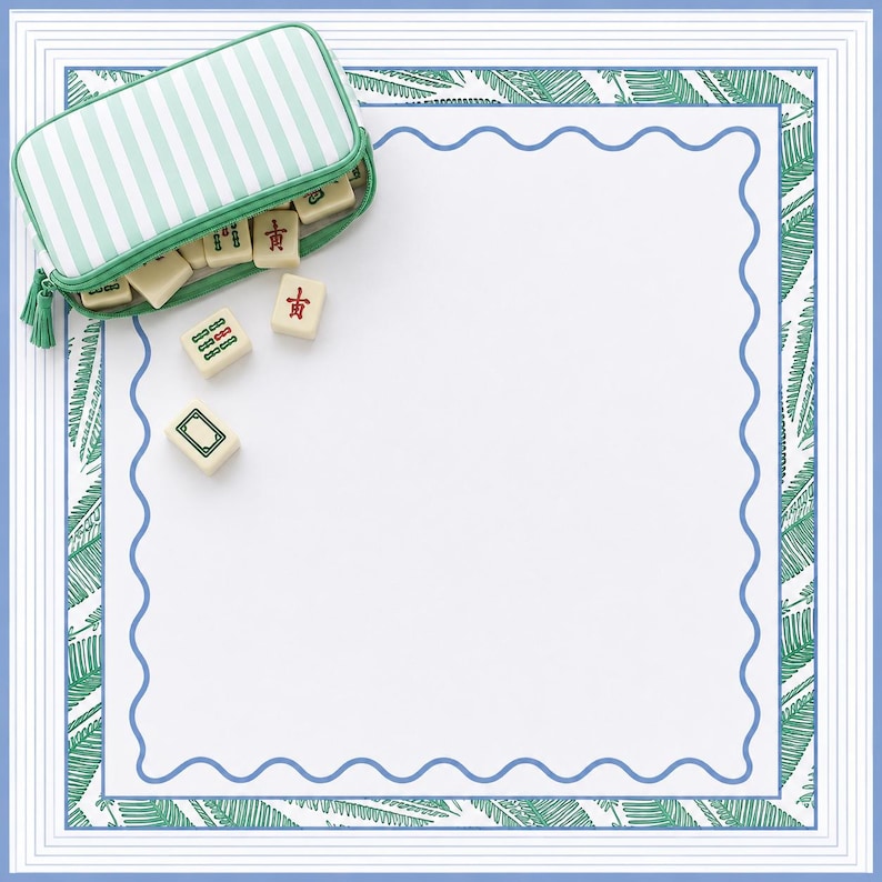 Coastal mahjong tile bag in green stripe resting on a blue and green mahjong mat with tiles on a wooden table.