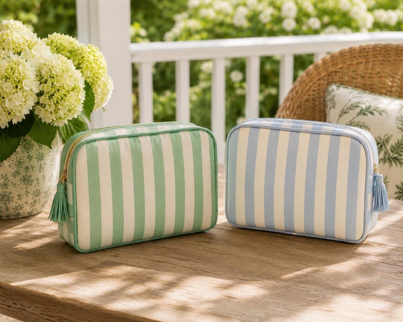 Coastal blue and sage green mahjong tile bags in gree resting on a wooden table.