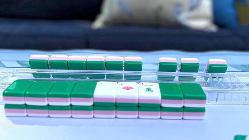 preppy mahjong tiles on rack. tiles are green and pink and perfect for a summer game night