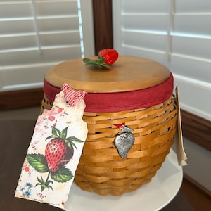 May include: A white ceramic mug with a black handle and the text "But First, Coffee" in a bold, black font. The mug is set against a plain white background, highlighting its simple design.