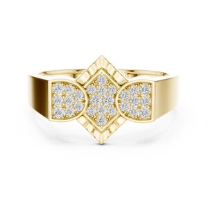 May include: A gold ring with a geometric design. The ring features a central diamond-shaped setting and two semi-circular settings, all encrusted with small, sparkling stones. The band is a solid, polished gold.