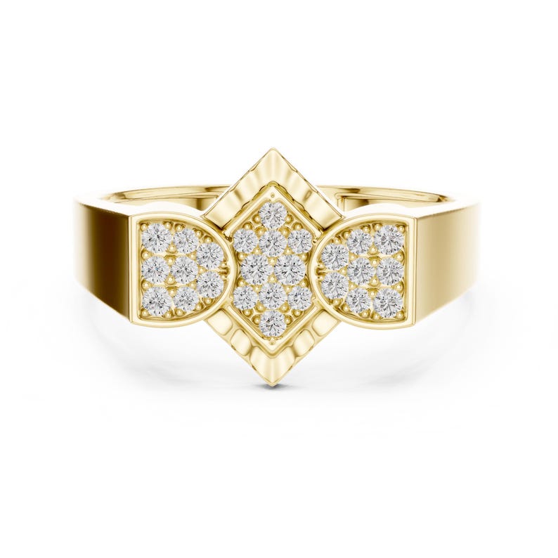 May include: A gold ring with a geometric design. The ring features a central diamond-shaped setting and two semi-circular settings, all encrusted with small, sparkling stones. The band is a solid, polished gold.