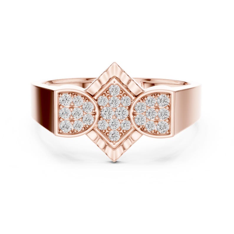 May include: Rose gold ring featuring a geometric design with a central diamond-studded rhombus and two semi-circular sections, also adorned with diamonds. The band has a rectangular shape.