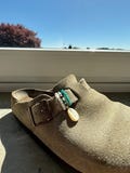 Birkenstock Boston charms with a shell product logo