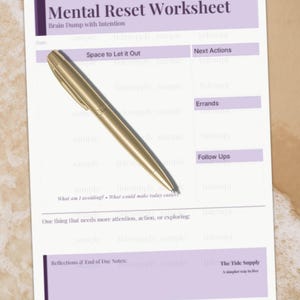 May include: A Mental Reset Worksheet with the text "Mental Reset Worksheet" and "Brain Dump with Intention". A gold pen rests on the worksheet. The worksheet has sections for "Space to Let it Out", "Next Actions", "Errands", and "Follow Ups".