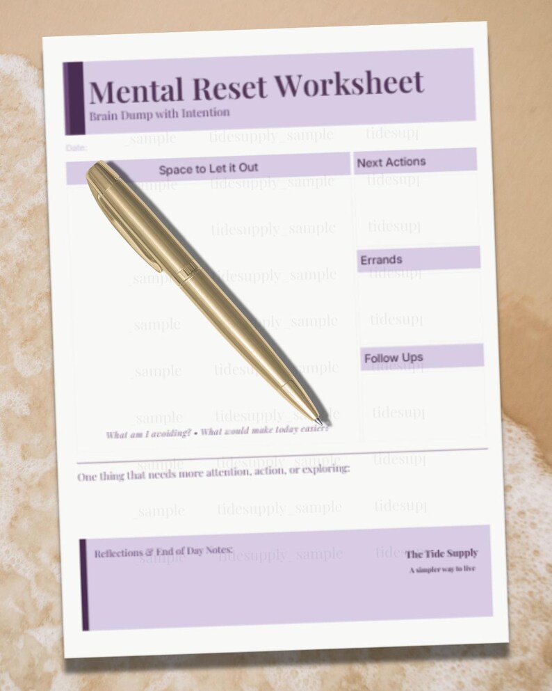 May include: A Mental Reset Worksheet with the text "Mental Reset Worksheet" and "Brain Dump with Intention". A gold pen rests on the worksheet. The worksheet has sections for "Space to Let it Out", "Next Actions", "Errands", and "Follow Ups".