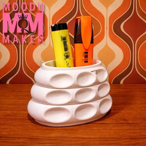 May include: A set of three ceramic mugs with a speckled, matte finish. The mugs are in shades of cream, light gray, and dark gray. Each mug has a simple, minimalist design, perfect for coffee or tea.