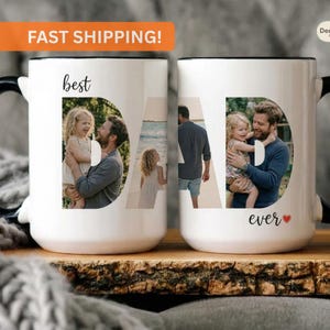May include: White ceramic mugs with black handles and rims. The word "best" is above the letter "D" which contains a photo of a man and child. The word "DAD" is formed with photos of a man and child. The word "ever" and a heart are below the letter "D".